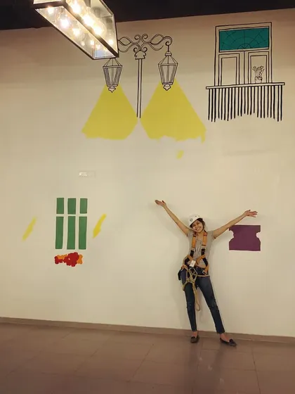 An early stage of the Wipro mural, with me harnessed up for safety. Large-scale projects often require special equipment to reach every part of the wall.