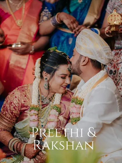 A tender forehead kiss from the groom, Rakshan, to his bride, Preethi, during their wedding ceremony. A quiet, heartfelt moment.