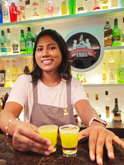 Our female mixologist presenting two perfect kiwi shots. We create delicious and visually appealing shots to get the party started.
