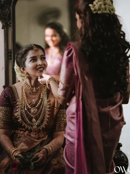A heartwarming moment between the bride and her sister or friend during the getting-ready process.