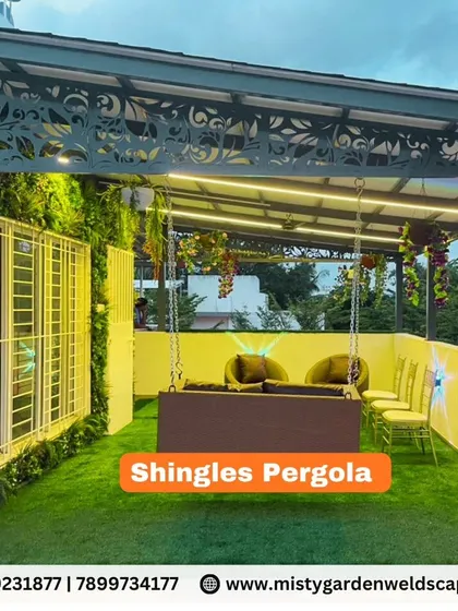A beautiful shingles pergola creating a cozy seating area on a terrace. The space is enhanced with a vertical garden wall, artificial grass, and a comfortable swing.