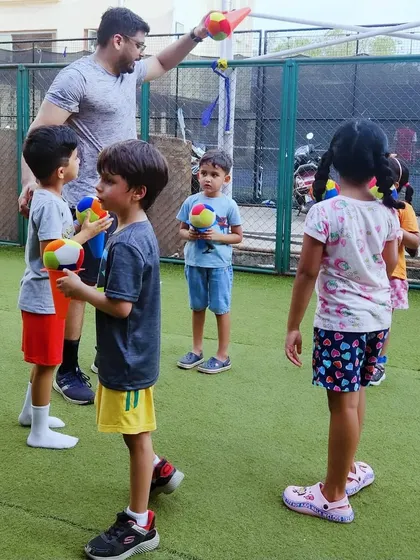 Getting ready for a ball game! I'm explaining the rules before we start, ensuring everyone understands how to play. This moment is key for teaching listening skills and sportsmanship.