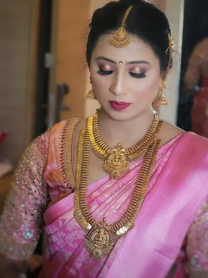 Another angle of this stunning bridal makeup. The soft pink and gold tones on the eyes are designed to catch the light beautifully, ensuring the bride looks radiant from every angle.