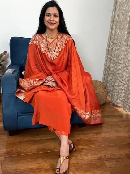 This orange suit with a heavy Banarasi dupatta is a look I love for its simplicity and elegance. The bright color of the suit is perfectly balanced by the richness of the dupatta.