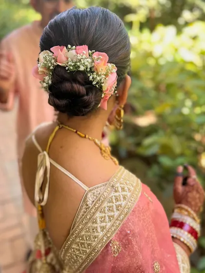 Another angle of the pink floral bun, a perfect choice for a daytime wedding.