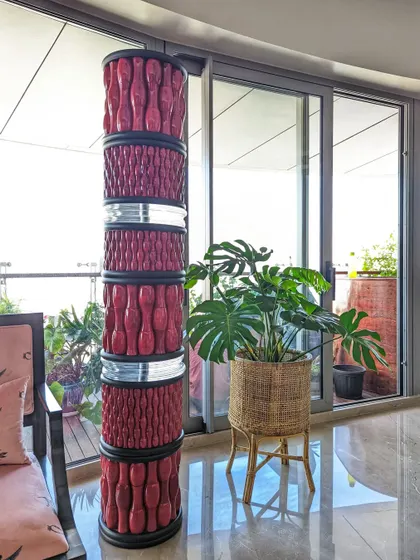 A beautiful Monstera plant in a rattan planter stand brings a touch of bohemian charm to this eclectic home. Its lush, fenestrated leaves add a natural, organic feel that complements the artistic decor.