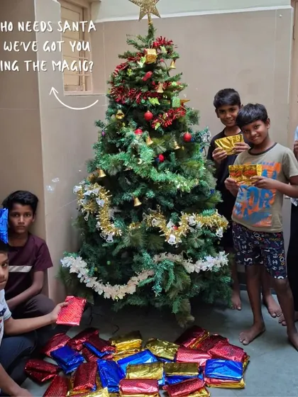 Who needs Santa when we've got you bringing the magic? Children at one of our libraries stand by a Christmas tree surrounded by gifts, a beautiful sight made possible by our generous donors.