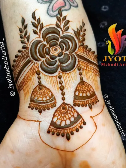 A beautiful designer wristband or bracelet design. This piece features a floral motif with hanging jhumkas, perfect for a party or as a starting point for a larger design.