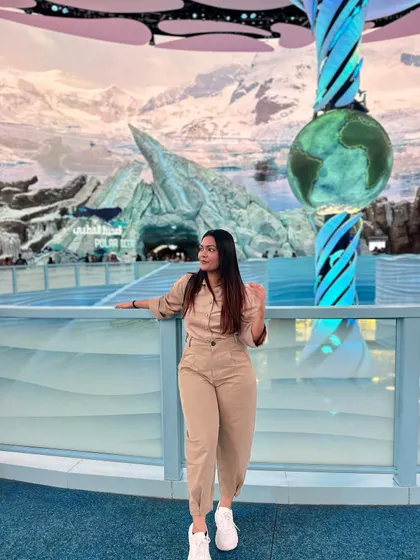 Inside the polar exhibit at SeaWorld. The beige jumpsuit stands out beautifully against the icy blue backdrop.
