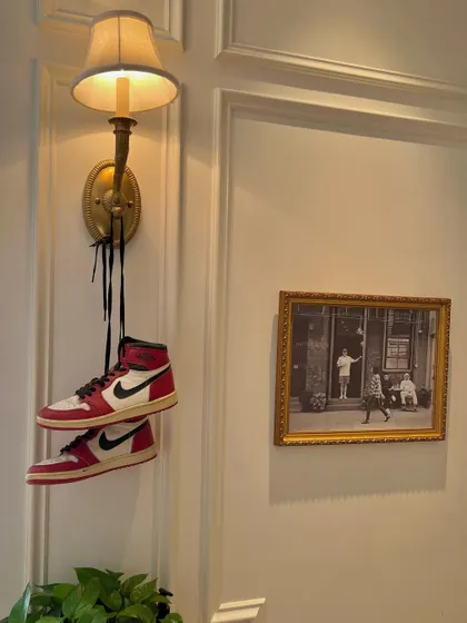 An artistic shot of my Air Jordan 1s hanging from a lamp. Street culture and style are a big part of my identity and influence both my music and my design work.