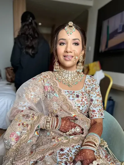 A relaxed shot of the bride getting ready. The makeup is designed to look flawless both up close and from a distance.