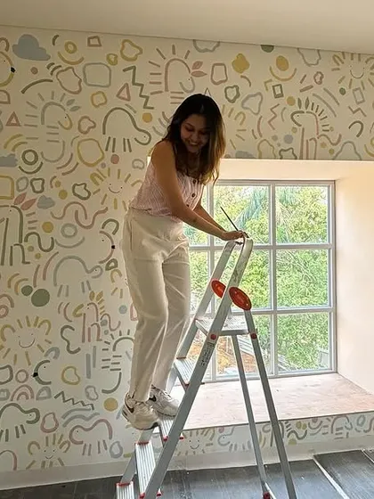 A full view of the whimsical doodle wall in progress. The pastel color palette keeps the busy pattern feeling soft and cheerful.