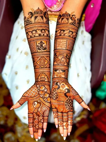 This design is packed with auspicious symbols for a wedding, including Lord Ganesha, a shehnai, and a kalash, alongside peacock motifs.