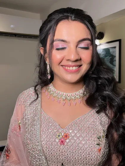 A detailed shot of the eye makeup. The soft pink shimmer makes her eyes pop, creating a romantic and dreamy effect perfect for an engagement.