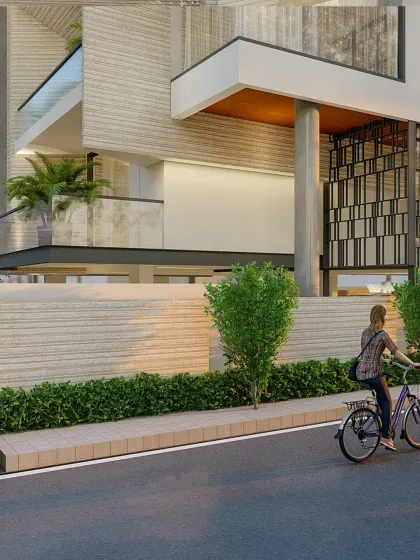 This view highlights the textured materials used on the boundary wall and lower levels of the facade, grounding the structure and connecting it to the streetscape.
