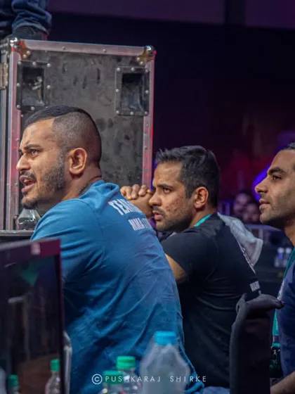 The commentary and production team, watching intently from the side. Another part of the machine that brings the event to life.