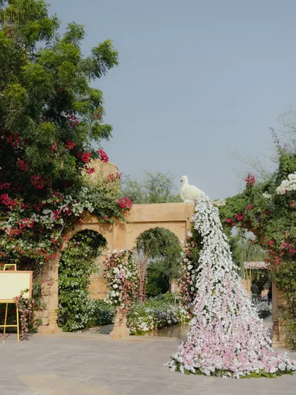 A unique floral peacock with a cascading tail of pink and white flowers served as a stunning centerpiece for this pastel wedding. We designed it to look as if it grew organically from the decor, a signature piece that was uniquely theirs without feeling loud.