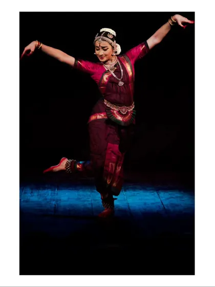 A dynamic leaping pose, capturing a moment of joy and exuberance in the dance.