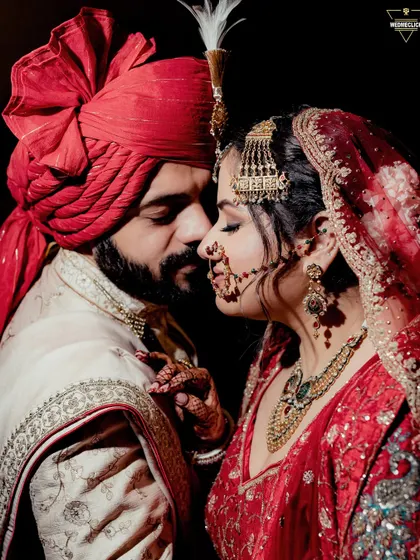 A close-up portrait capturing the quiet intensity and emotion between a bride and groom. The focus on their expressions and the rich details of their wedding attire makes this a powerful and timeless image.