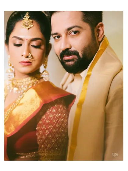 A stylish and intimate portrait of the couple. The groom's direct gaze and the bride's elegant profile create a powerful and modern image.