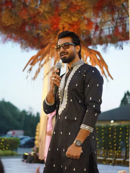 A moment of calm before the storm of the Baraat begins. As the wedding emcee, I'm ready to kick things off and get the party started.