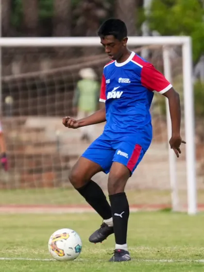A player controls the ball with composure. Playing against older, stronger teams is a fantastic learning opportunity.