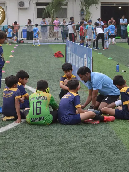 A coach giving instructions to our youngest players during the Blue Cubs League. Building a strong foundation of confidence and discipline from an early age.
