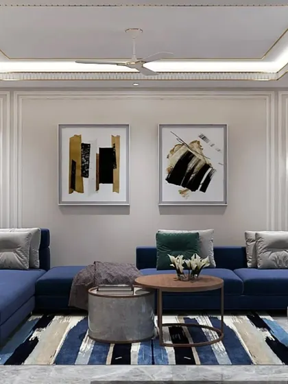 A modern living room with a large blue sectional sofa and a striped area rug. The false ceiling with cove lighting and minimalist wall art adds to the contemporary and clean aesthetic.
