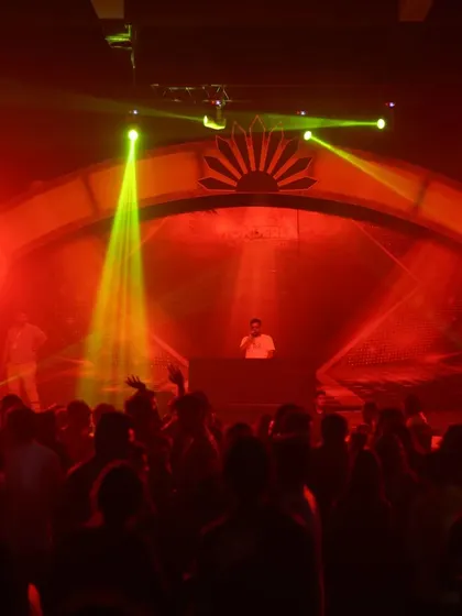 The stage is ablaze with red and yellow lights, creating a high-impact visual that matches the intensity of the music.