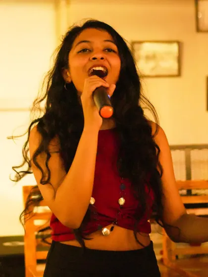 Singing my heart out at a live event. I'm comfortable performing a wide range of genres, and my passion for music shines through whether I'm singing a folk song or a pop hit.