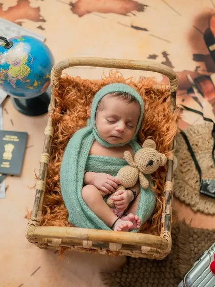 This little adventurer is holding his teddy bear tight, ready for his journey. The details like the passport and camera add to the story.