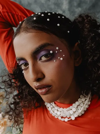 Another angle of the beauty look, showing the dramatic purple eyeshadow.