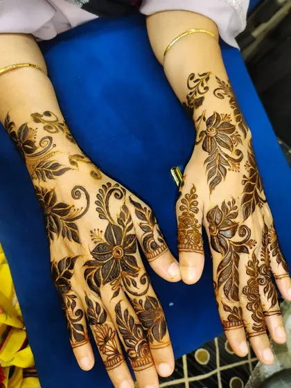 An elegant floral and vine pattern that extends from the fingers up the wrist.