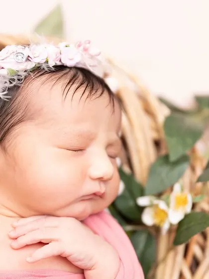 Pure love in its smallest form. This macro shot focuses on the serene face of a sleeping newborn, highlighting her soft skin and tiny features.