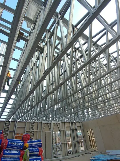 The interior of an industrial complex under construction, showcasing the massive steel truss structure I designed. This image demonstrates my capability in handling large-scale structural engineering and industrial architecture projects.