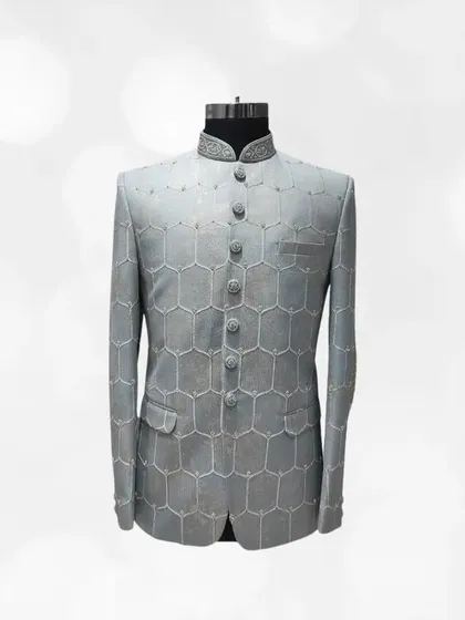 A modern take on a classic, this grey Jodhpuri suit showcases a geometric honeycomb pattern. It's a sophisticated and stylish option from our pre-loved menswear.