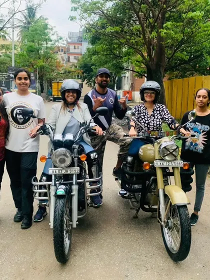 A group of graduates pose with their bikes and coaches. This is the supportive community you join when you train with us.