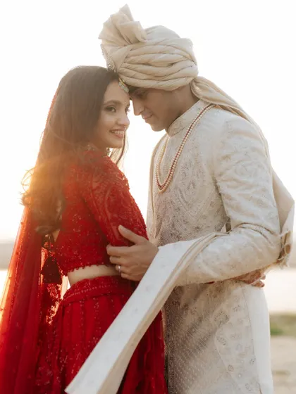 A tender moment between the couple, with the setting sun creating a beautiful backlight. This soft, romantic style is one of my favorites.
