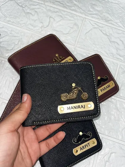 Here's another example of a custom men's wallet, this time in black with a cool motorcycle charm and the name "Maniraj." The textured material gives it a premium feel.