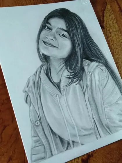 A casual portrait of a young woman in a hoodie. I can create a realistic sketch from any of your favorite photos.