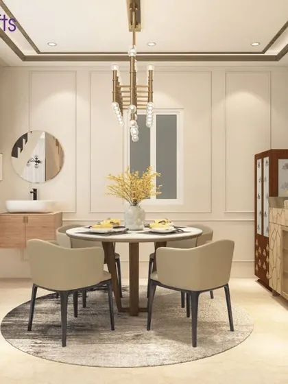 The dining area in the Heritage County villa. A round table with neutral chairs is set under a modern chandelier, with a mirrored partition adding a touch of glamour and reflecting light.