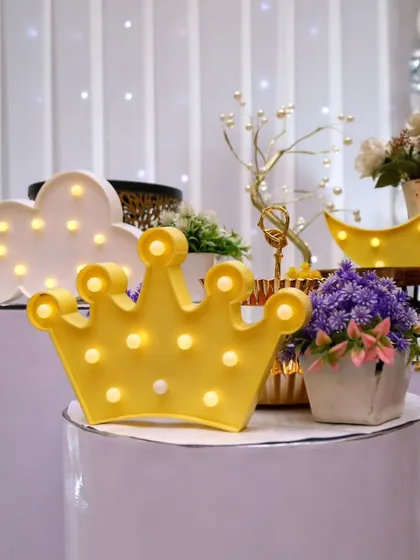 Close-up of charming light-up props, including a crown, cloud, and moon, perfect for a fairy or celestial theme.