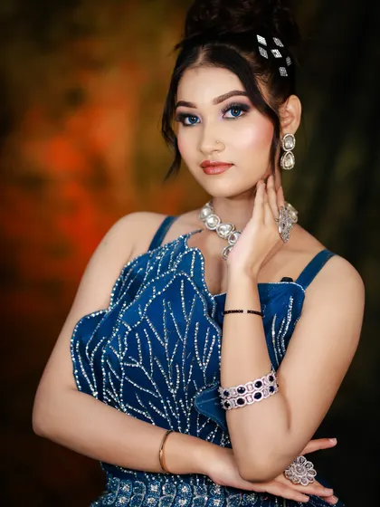 The final look, showcasing a sophisticated updo and makeup that enhances the model's features for an evening event.