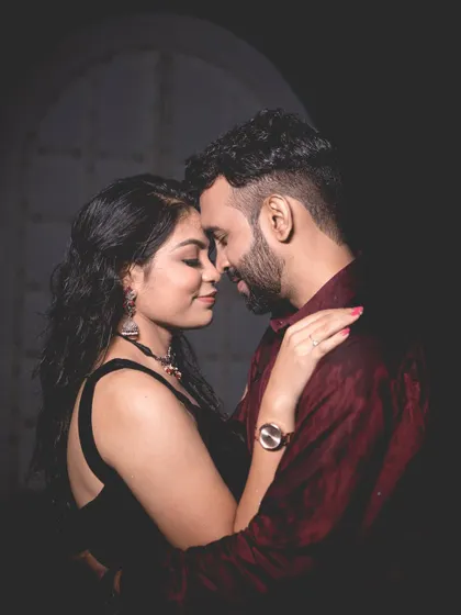 A classic and intimate close-up portrait of the couple, with soft lighting that highlights their connection.