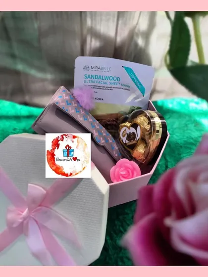 A lovely Women's Day gift in a hexagonal box. It includes a sandalwood sheet mask and other small pampering items to show appreciation.