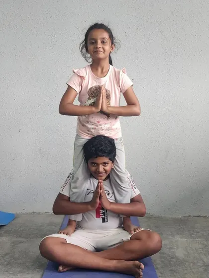 A clear and happy example of our seated partner pose, perfect for beginners to acro-yoga.