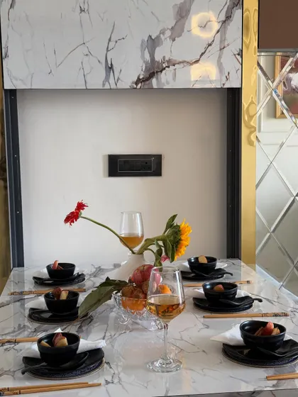 Another perspective of the dining table decor, highlighting the floral arrangement and the quality of the materials used in this custom furniture piece.