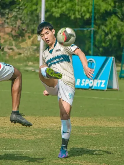 A player shows off some flair, controlling the ball with their thigh.