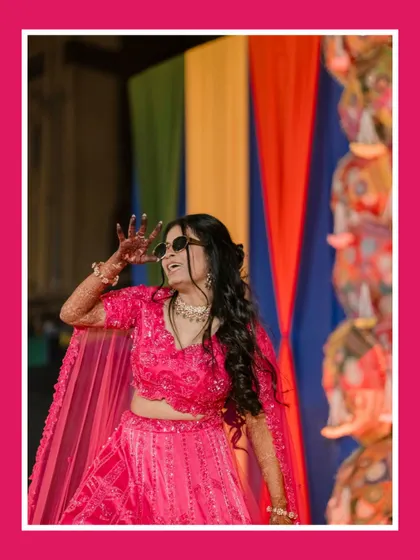 The bride owns the dance floor. This shot captures her vibrant energy and fun-loving spirit during her Sangeet performance, a perfect memory of the night's celebrations.