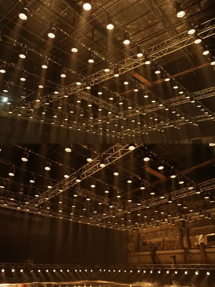 A wide shot of the 150-Parcan grid, creating dramatic shafts of light through haze for the Mahindra commercial.